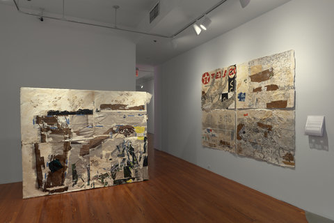 Installation image of two large, almost wall sized canvases standing upright in front of the white walls. 