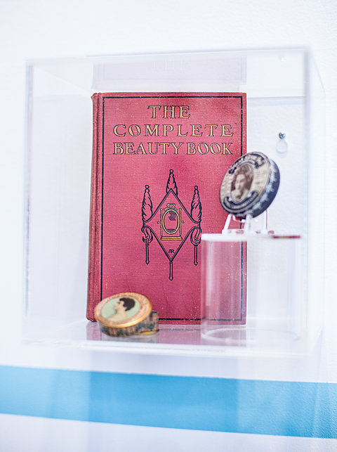A display case holding a red book titled "The Complete Beauty Book."