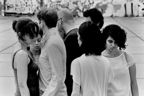 Black and white sketch of a group of people. Some with their backs to the viewer, others facing the viewer. 