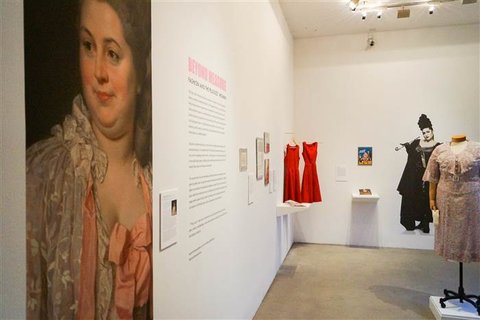 Installation view of the exhibition featuring several costumes. 