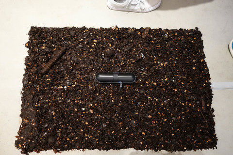 Close-up image of an object from the exhibition featuring what appears to be a rectangular organization of brown dirt. 