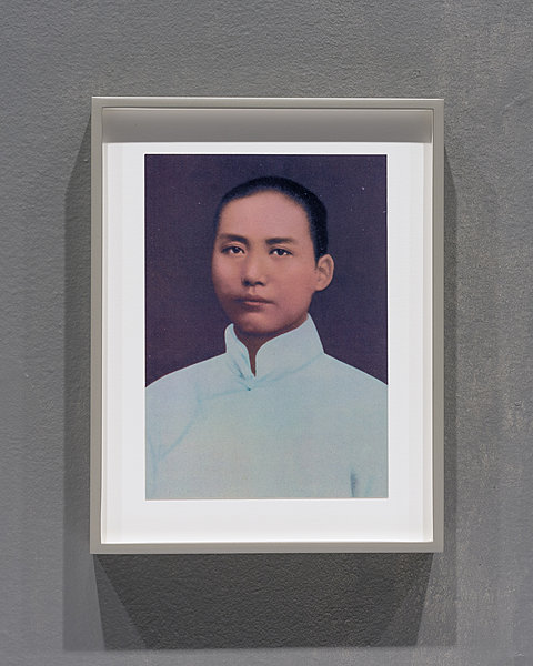 A framed picture of Chairman Mao.